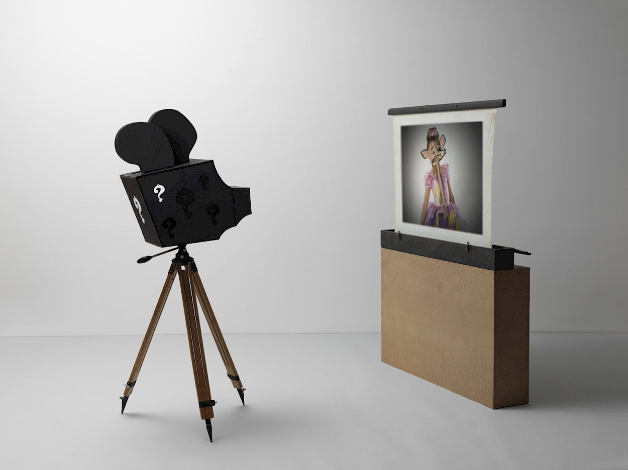 Simon Fujiwara Whos Childhood 2021 sculptural video installation cardboard electrical tape Plexiglas antique tripod projector projection screen 164 x 73 x 73 cm 64 58 x 28 34 x 28 34 in projector on tripod Image  Jörg von Bruchhausen